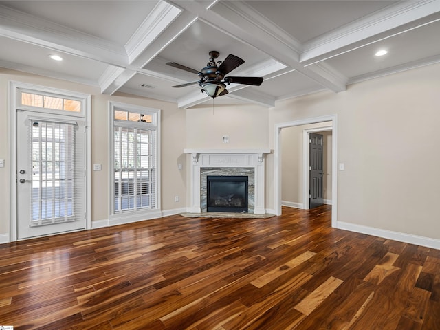 unfurnished living room featuring beam ceiling, a fireplace, wood finished floors, coffered ceiling, and baseboards