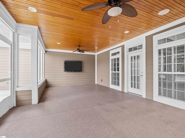 unfurnished sunroom with wooden ceiling and a ceiling fan