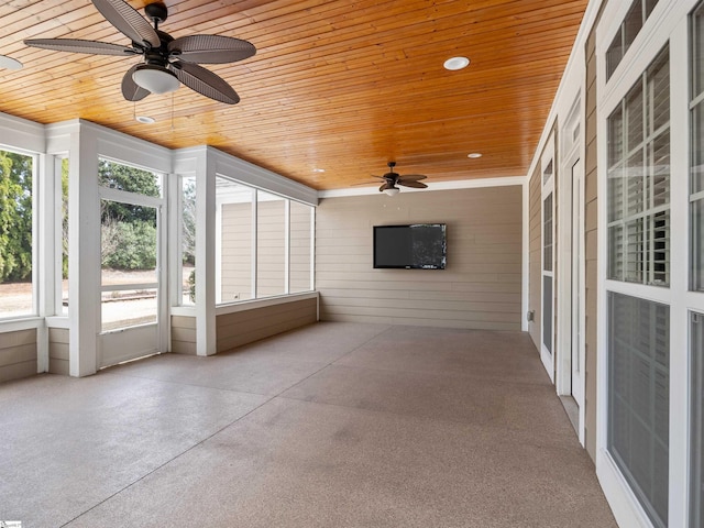 unfurnished sunroom with wooden ceiling and a ceiling fan