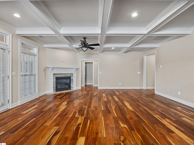 unfurnished living room with a fireplace, baseboards, and wood finished floors