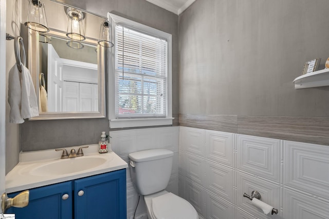 bathroom featuring crown molding, vanity, and toilet