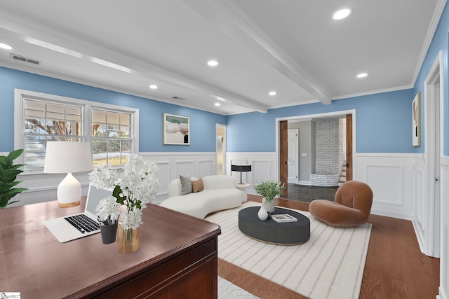 living room with crown molding, hardwood / wood-style flooring, and beamed ceiling