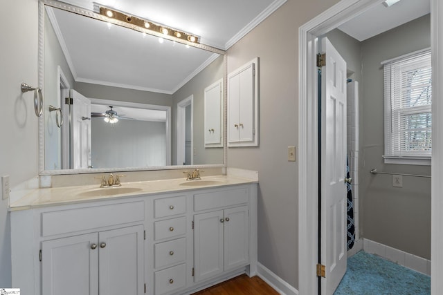 bathroom with crown molding, vanity, and ceiling fan