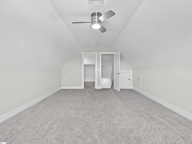 additional living space with lofted ceiling, carpet floors, and ceiling fan