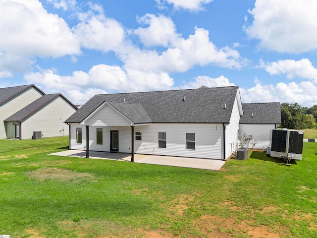 rear view of property with central AC, a lawn, and a patio