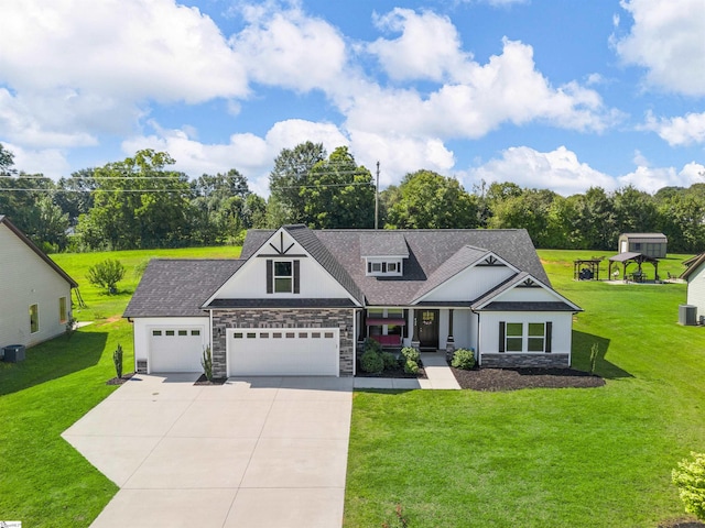 view of front of home with central AC unit, a garage, and a front lawn