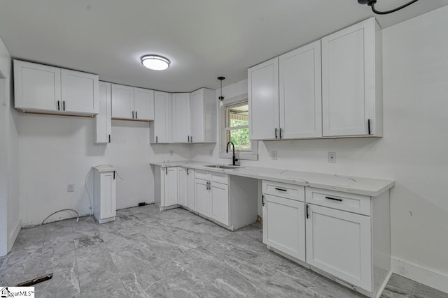 kitchen featuring sink and white cabinets