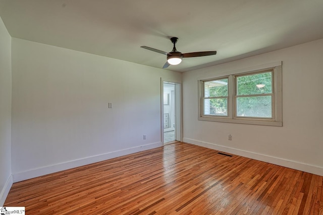 empty room with light hardwood / wood-style floors and ceiling fan