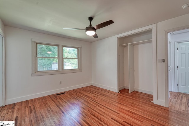 unfurnished bedroom featuring a closet, ceiling fan, and light hardwood / wood-style flooring