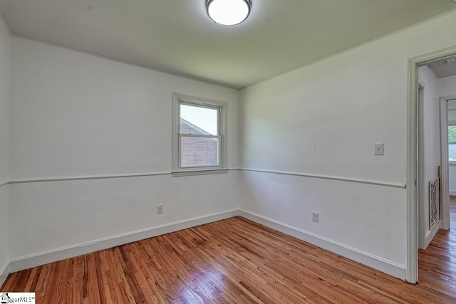 spare room with hardwood / wood-style flooring