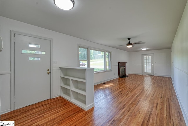 foyer entrance featuring ceiling fan and light wood-type flooring