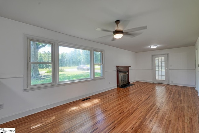 unfurnished living room with ceiling fan and wood-type flooring