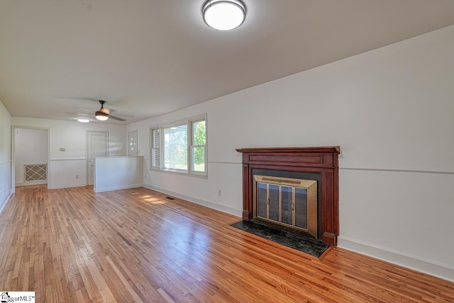 unfurnished living room with ceiling fan and light wood-type flooring