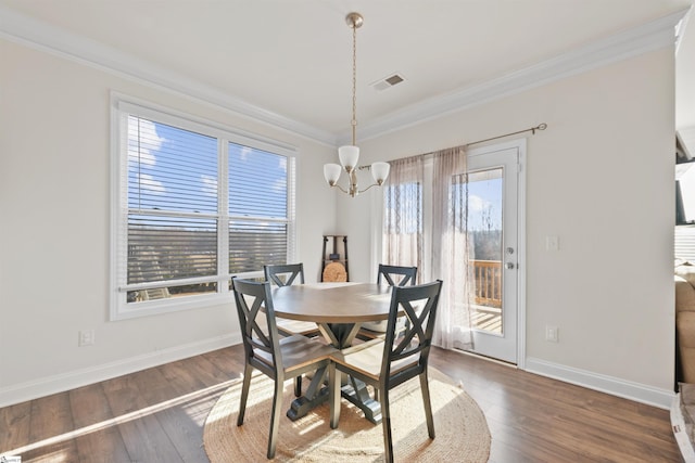 dining room with crown molding, dark hardwood / wood-style flooring, and a wealth of natural light