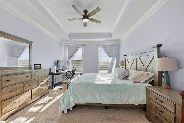 bedroom featuring crown molding, light colored carpet, a raised ceiling, and ceiling fan