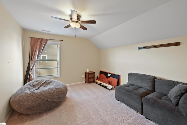 sitting room with vaulted ceiling, light colored carpet, and ceiling fan