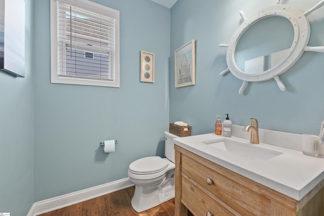 bathroom with hardwood / wood-style flooring, vanity, and toilet