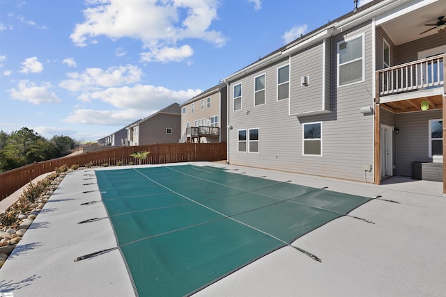 view of pool with ceiling fan and a patio area