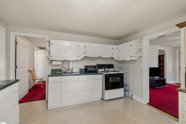 kitchen featuring white cabinetry, range with electric cooktop, and a textured ceiling