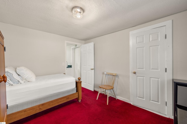 bedroom featuring carpet floors and a textured ceiling