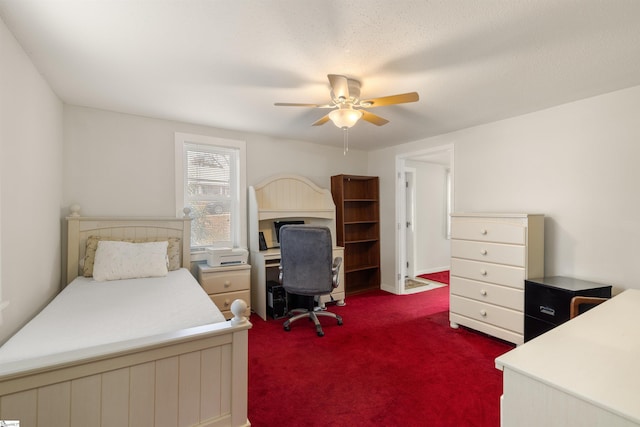 bedroom featuring ceiling fan and dark colored carpet