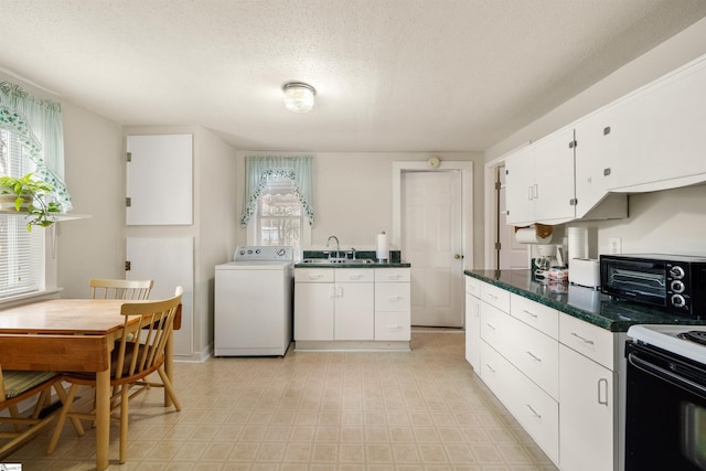 kitchen with white cabinetry, washer / clothes dryer, sink, and a healthy amount of sunlight