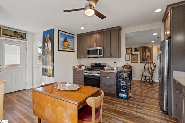 kitchen featuring dark wood-type flooring, appliances with stainless steel finishes, and dark brown cabinets