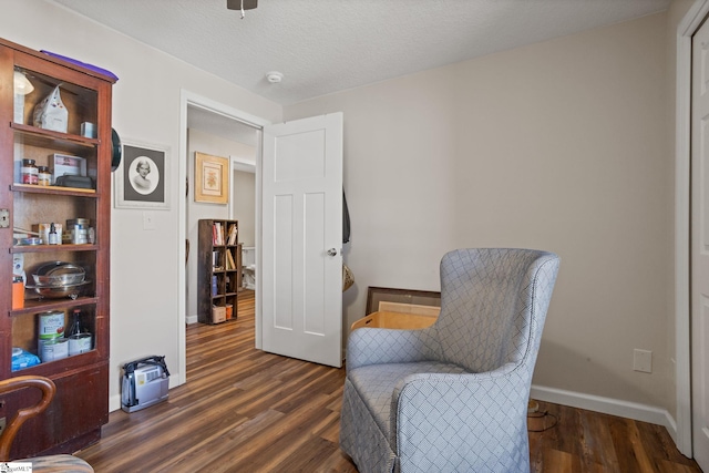 sitting room with dark hardwood / wood-style flooring and a textured ceiling