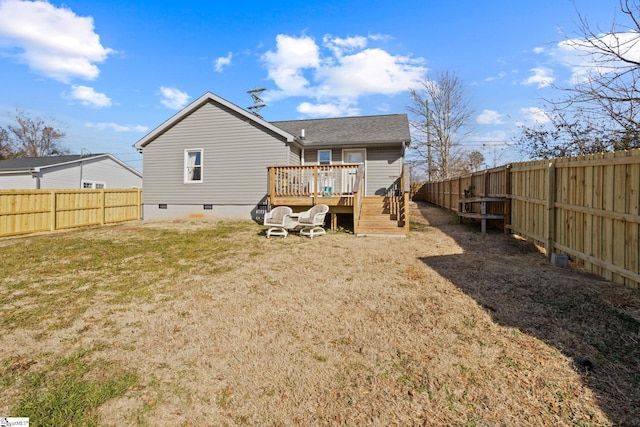 rear view of property with a wooden deck and a lawn