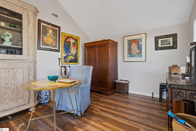 dining space with lofted ceiling and dark hardwood / wood-style floors