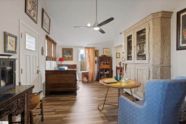 living area featuring ceiling fan, dark hardwood / wood-style flooring, and high vaulted ceiling