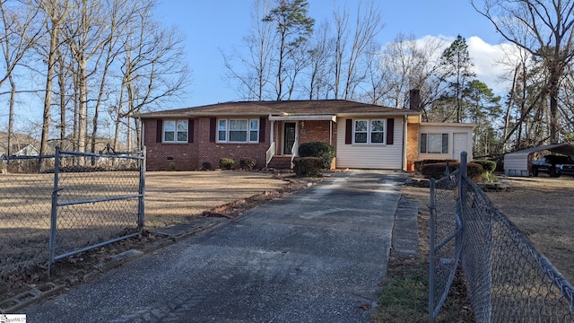 view of front facade featuring aphalt driveway, crawl space, brick siding, and a fenced front yard