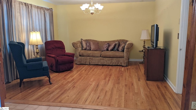 living room with an inviting chandelier and light hardwood / wood-style floors