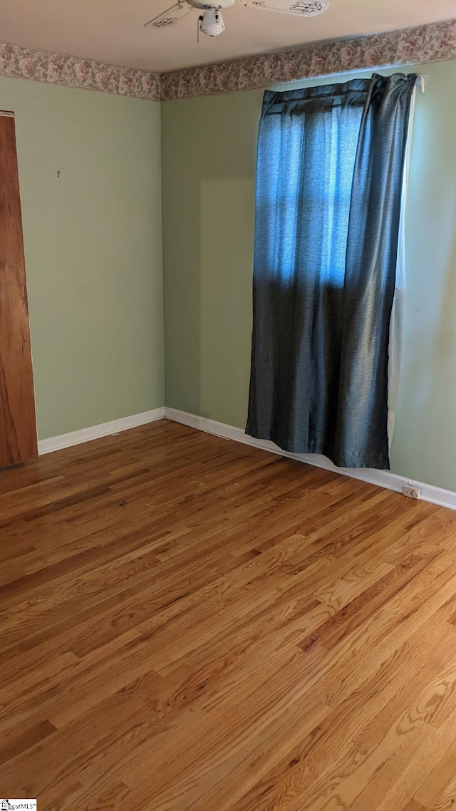 spare room featuring ceiling fan and light wood-type flooring