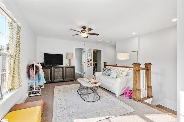 living room featuring ceiling fan and carpet