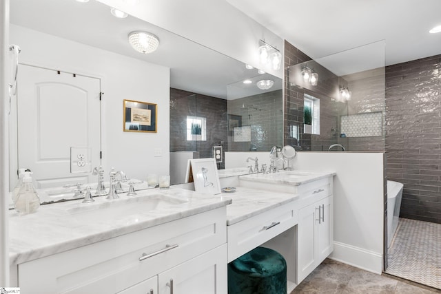 bathroom with tiled shower and vanity