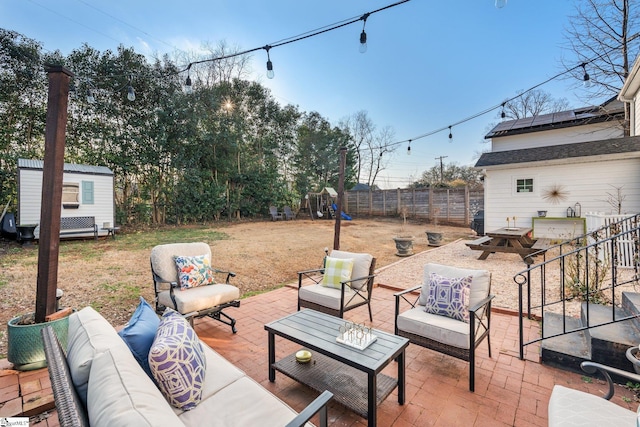 view of patio / terrace with an outdoor living space and a storage shed