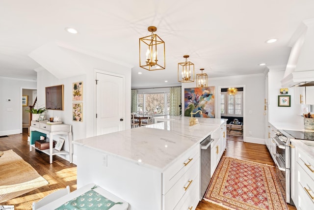 kitchen with white cabinetry, light stone counters, decorative light fixtures, a center island, and double oven range