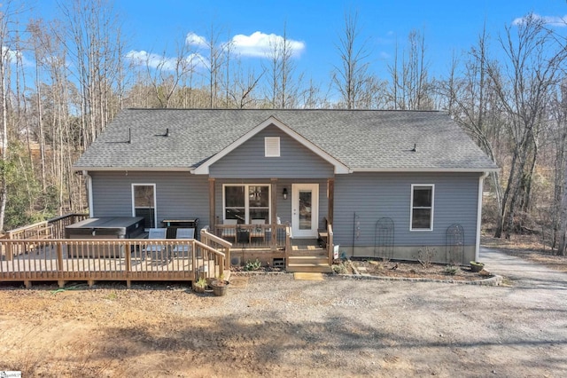 view of front of home featuring a wooden deck and a hot tub