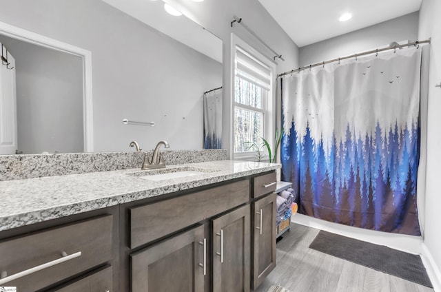 bathroom with a shower with curtain, vanity, and hardwood / wood-style floors