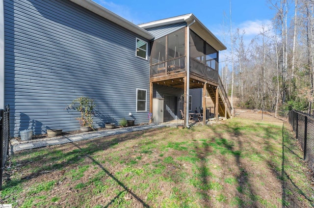 back of property with a sunroom