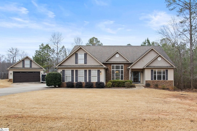 view of front facade with a garage and a front yard