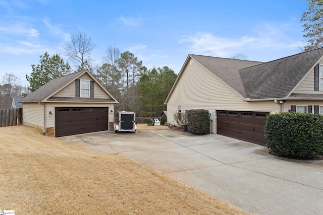 view of side of property featuring central AC and a garage