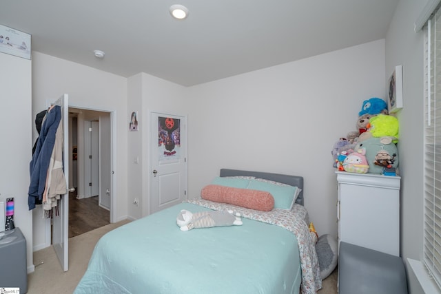 bedroom featuring light carpet