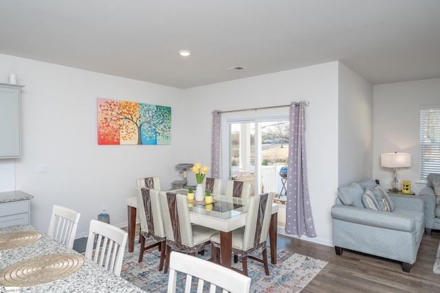 dining area featuring dark wood-type flooring