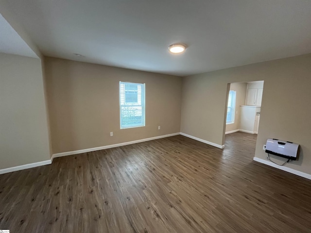 spare room with dark hardwood / wood-style flooring