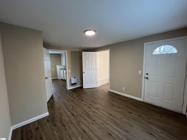 entrance foyer with heating unit and dark wood-type flooring