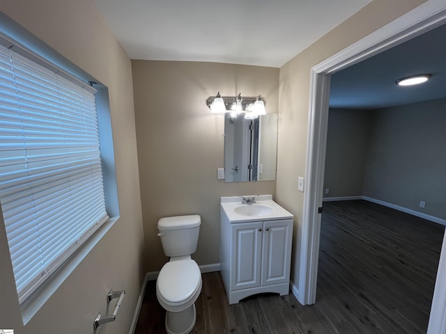 bathroom featuring vanity, hardwood / wood-style floors, and toilet