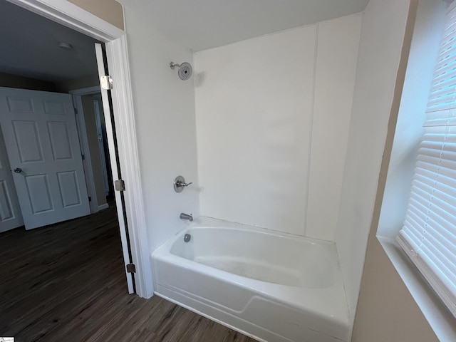 bathroom with shower / bathtub combination and hardwood / wood-style floors