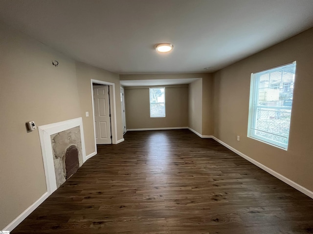 unfurnished living room featuring dark hardwood / wood-style floors